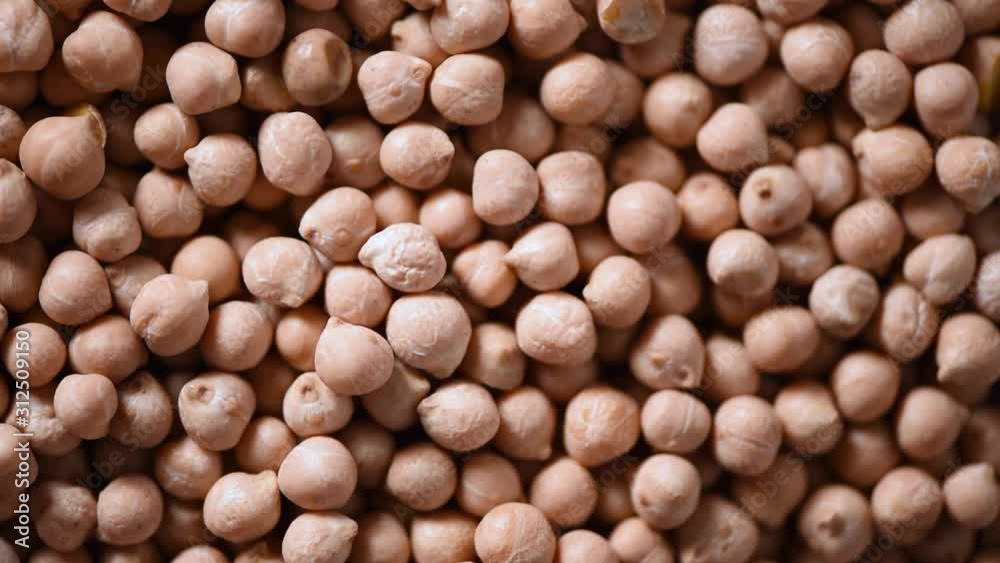 Raw organic dried chickpea texture on rotating background. Vegan healthy nutrition. Top view, copy space, healthy lifestyle concept. Raw organic dried chickpea texture on rotating background. Vegan healthy nutrition. Top view, copy space, healthy lifestyle concept.