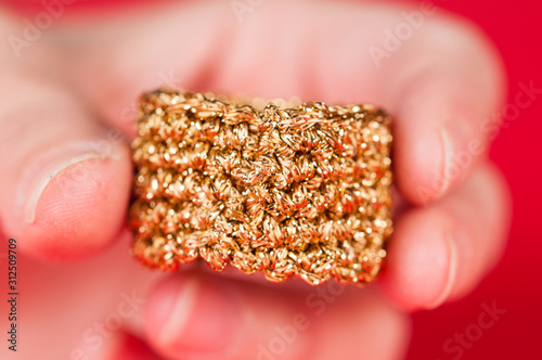 Dining napkin with gold napkin ring on red background