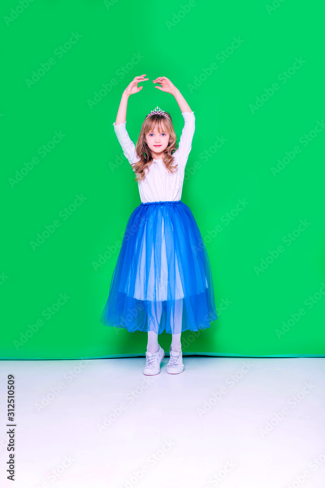 Beautiful blond girl stands and jump at the green background. Spring. Discounts and seasonal sale. Isolated. Beautiful blond girl stands and jump at the green background. Spring. Discounts and seasonal sale. Isolated.