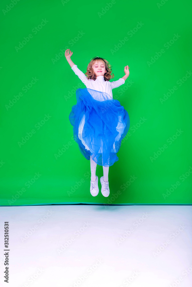 Beautiful blond girl stands and jump at the green background. Spring. Discounts and seasonal sale. Isolated.
