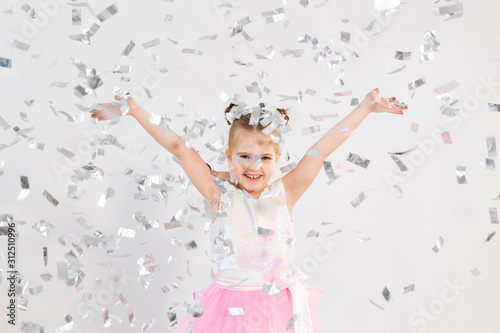 Party, holidays, birthday, new year and celebration concept - Cute child throwing confetti.