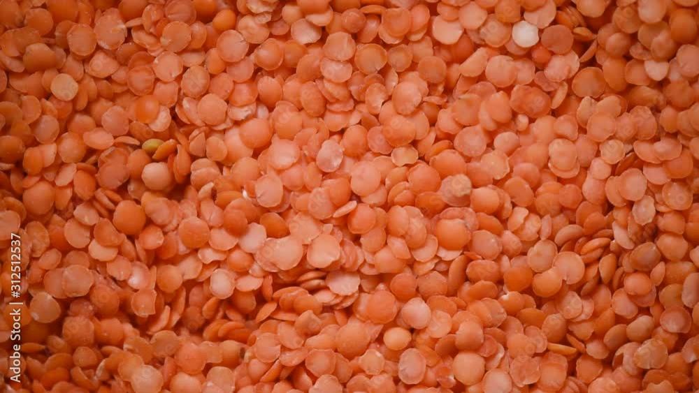Red raw organic lentils texture rotation. Food ingredient background. Top view Red raw organic lentils texture rotation. Food ingredient background. Top view