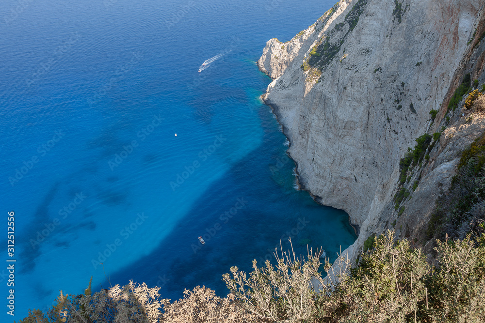 Seascape - view of the bay with blue water from a high cliff standing on the shore