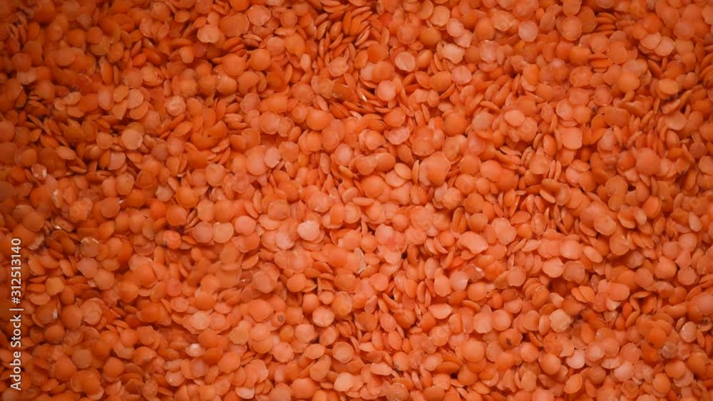 Red raw organic lentils texture rotation. Food ingredient background. Top view Red raw organic lentils texture rotation. Food ingredient background. Top view