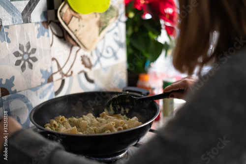 Preparing Delicious Pasta with Broccoli in a Sunlit Kitchen in Rome