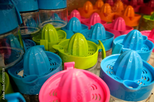 Multi colored plastic squeezers at market counter