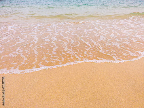 View of blue yellow Water wave ocean sea splash break to a beach sand sandy summer holiday aquamarine azure turquoise vacation tranquil scene copy space background