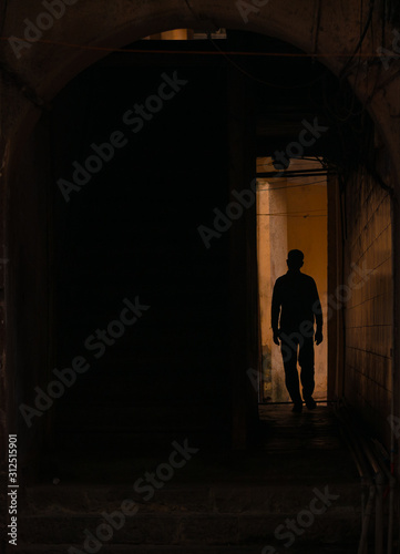 Silhouette of Man Walking in Tunnel.