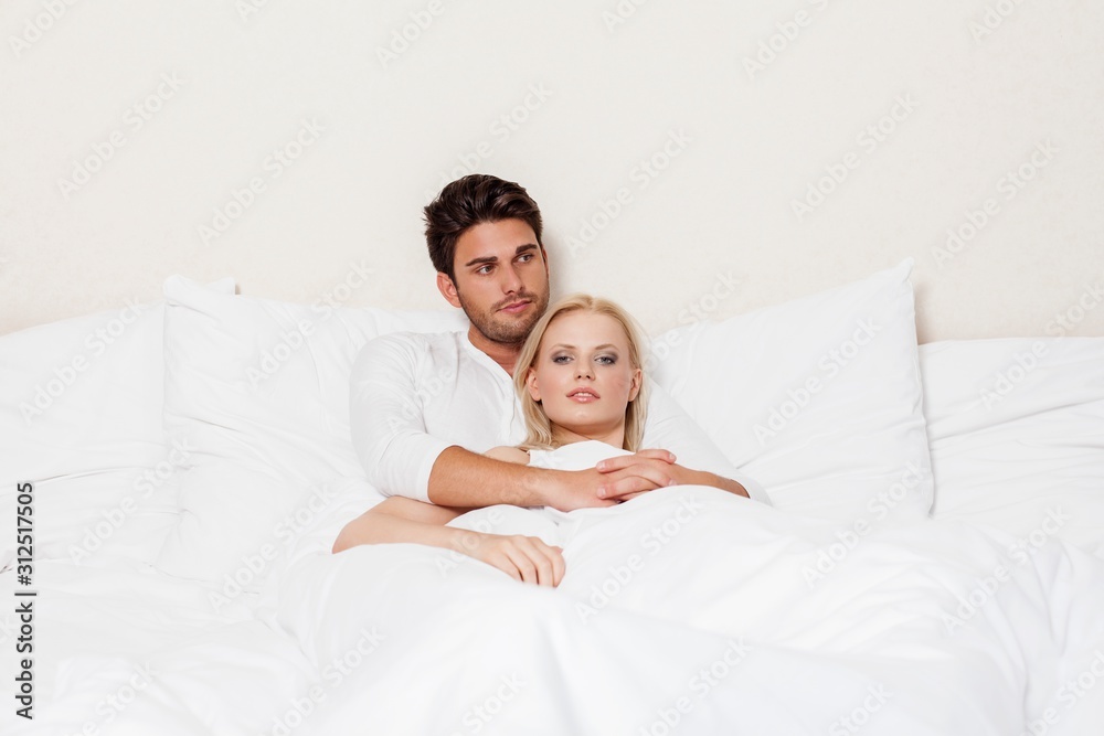 Fototapeta premium Loving young couple relaxing in bed