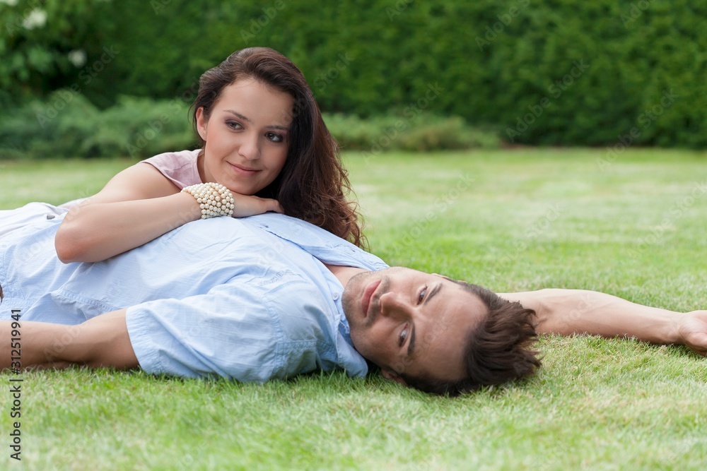 Loving young couple relaxing in park Loving young couple relaxing in park