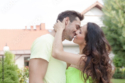 Side view of romantic young couple kissing outdoors