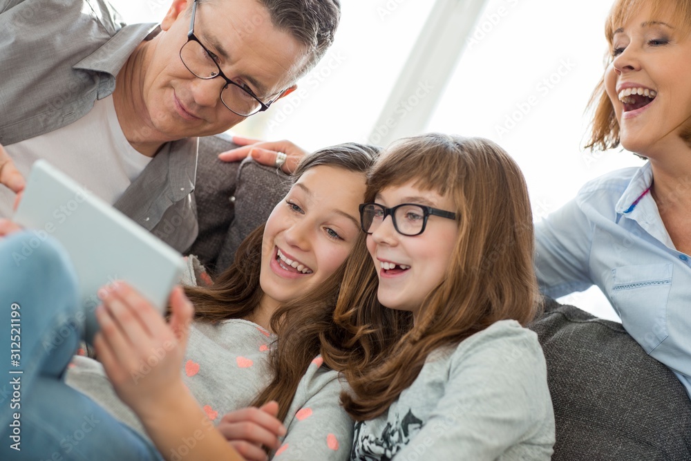 Cheerful family using tablet PC at home Cheerful family using tablet PC at home
