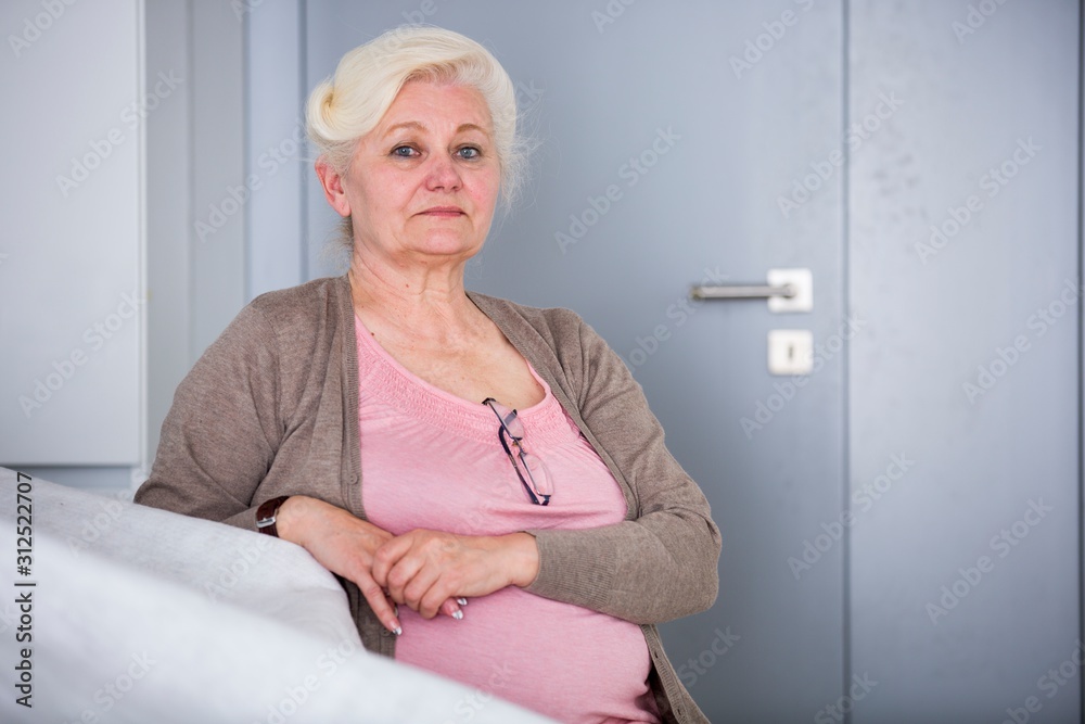Portrait of confident senior woman sitting in house Portrait of confident senior woman sitting in house