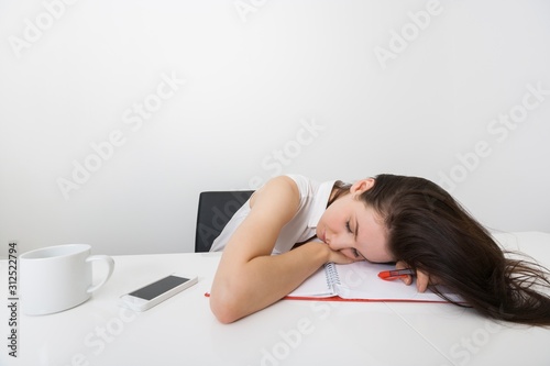 Tired businesswoman sleeping at desk in office