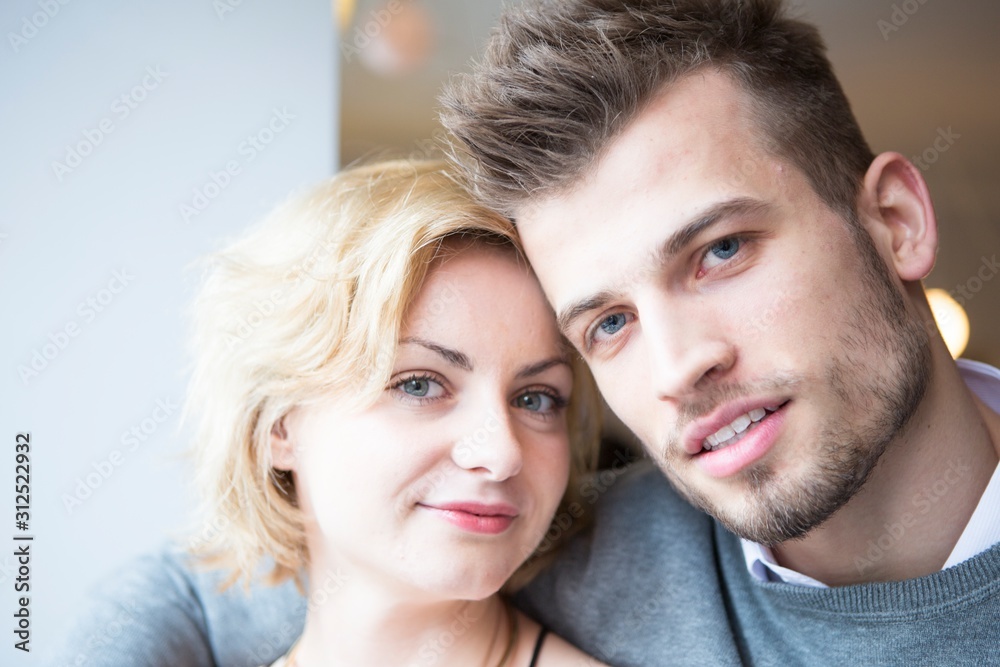 Close-up portrait of young couple in cafe