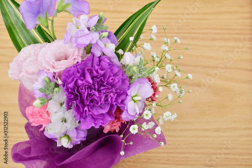 Bouquet, wood grain background. The world's first blue-violet carnation 