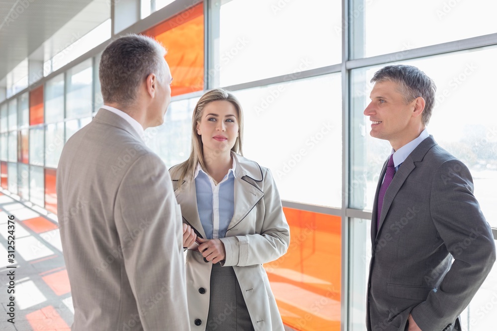 Businesspeople communicating on train platform Businesspeople communicating on train platform
