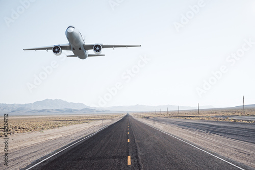 Road with taking off airplane.