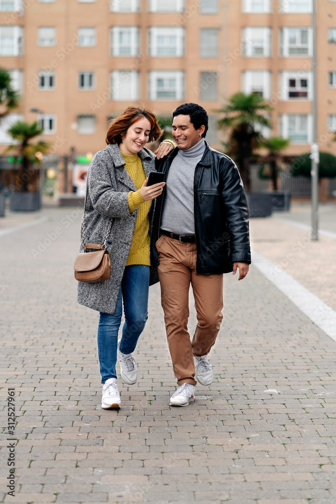 Happy couple walking together in the city