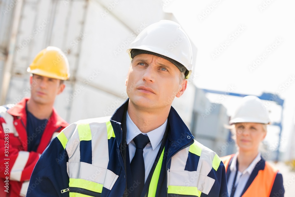 Team of confident workers in shipping yard Team of confident workers in shipping yard