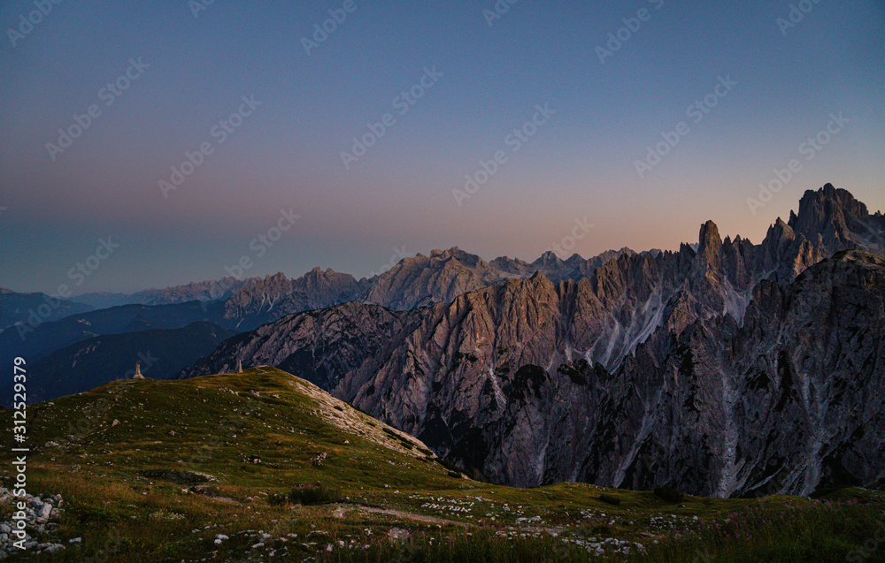 Panoramic view of famous Dolomites mountain peaks glowing in beautiful golden evening light at sunset in summer, South Tyrol, Italy