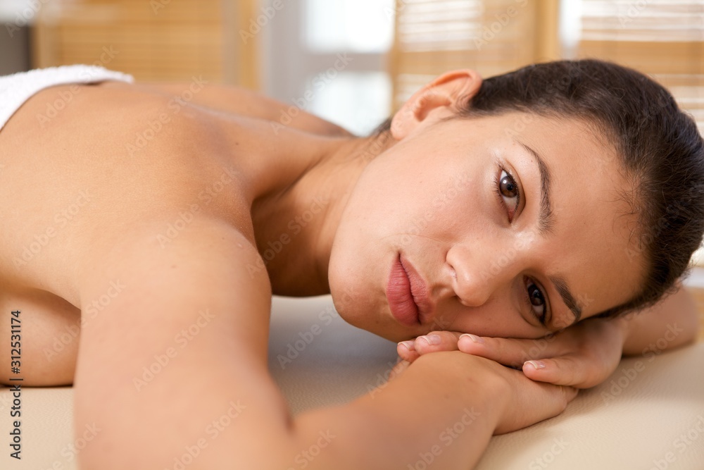 Portrait of young woman relaxing on massage table Portrait of young woman relaxing on massage table