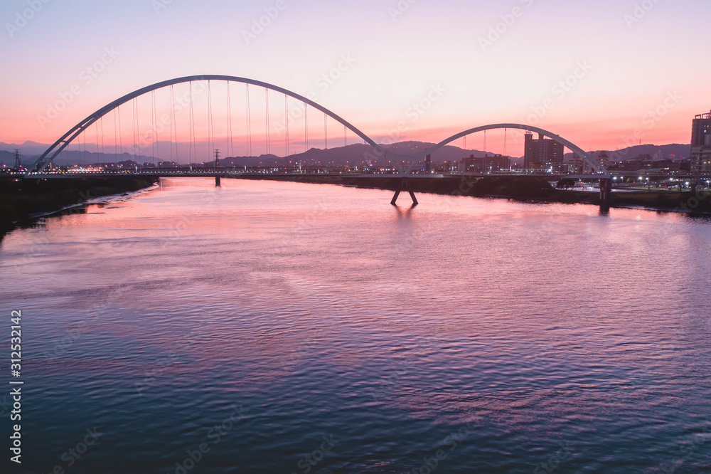 Naklejka premium Crescent Bridge - landmark of New Taipei, Taiwan with beautiful illumination at day, aerial photography in New Taipei, Taiwan.