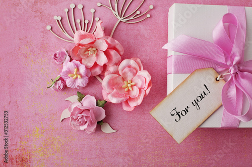 greeting card with gift box and flowers on pink paper background. Valentine's Day, mother's day, borthday or other celebration