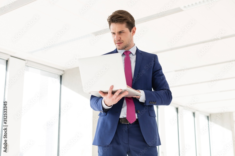 Young businessman using laptop in new office Young businessman using laptop in new office