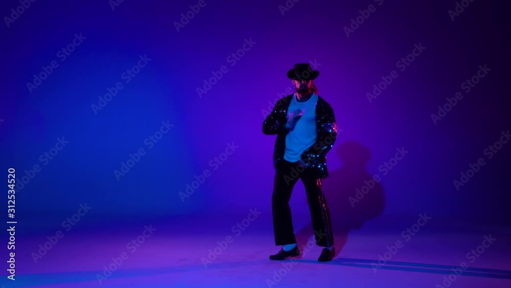 Young stylish teenager is showing dance moves. Isolated over blue background. Young stylish teenager is showing dance moves. Isolated over blue background.