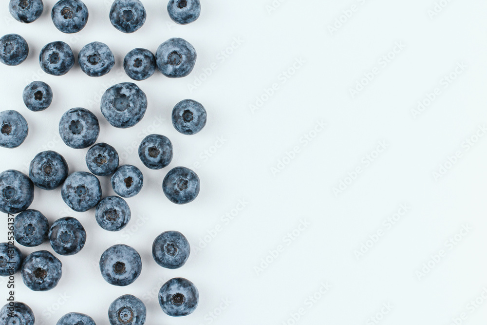 Ripe blueberries on a white background copy space. Large blue berries. Summer harvest of berries. Blueberry border. Ripe blueberries on a white background copy space. Large blue berries. Summer harvest of berries. Blueberry border.