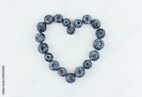  Blueberry heart on a white background copy space. Blue berry heart.