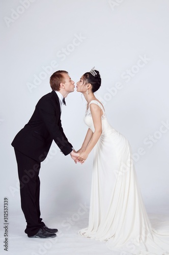 Photo of Bride and groom kissing 