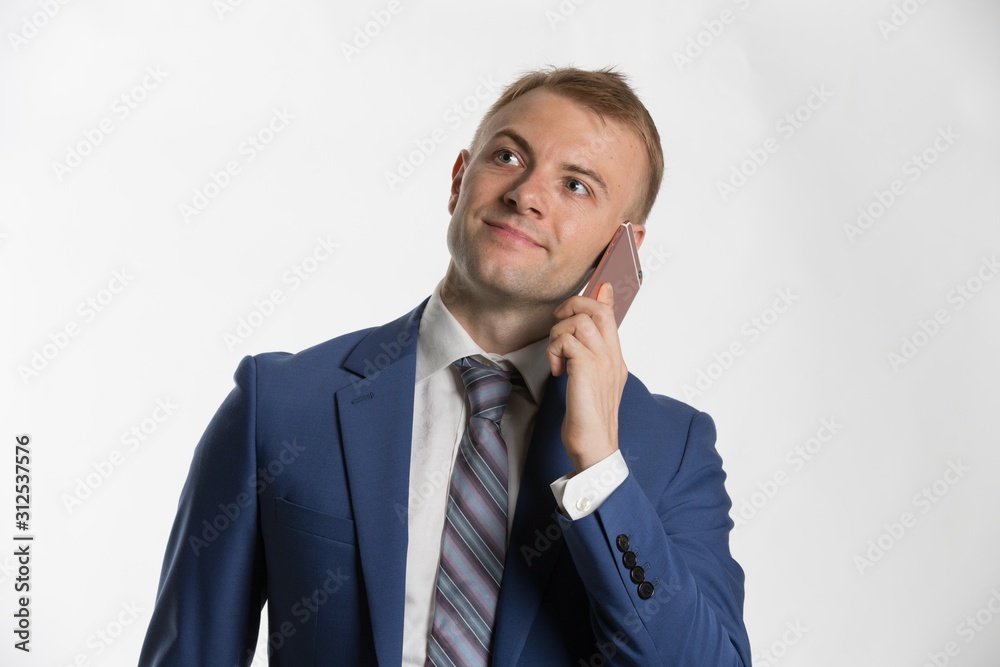 Young attractive businessman talking on smartphone
