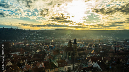 Germany, World famous skyline of medieval city esslingen am neckar from above in warm sunset light in winter with smoke of christmas market