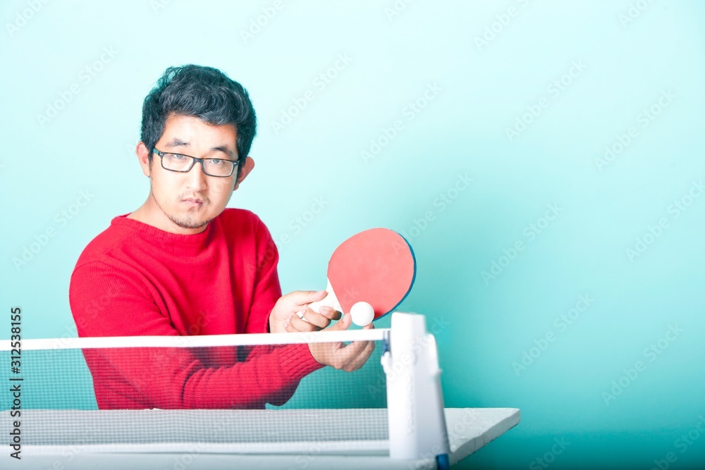 Asian man playing table tennis