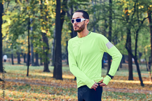 Man preparing for jogging / exercising in the park.