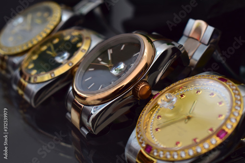 Luxury watches placed on a glittering glass floor