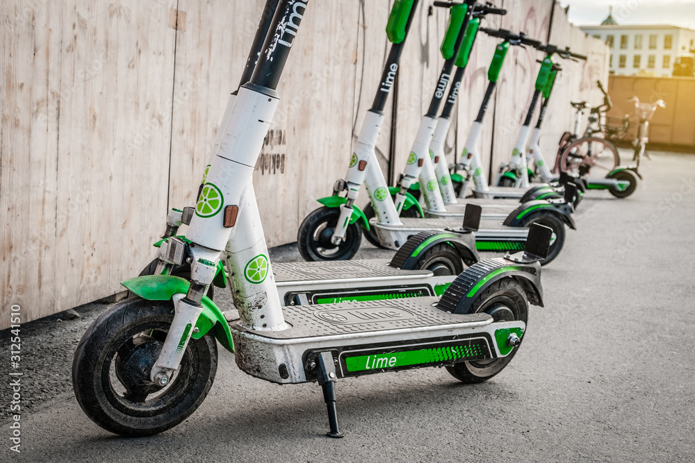 Electric E scooter , escooter or e-scooter of the ride sharing company LIME  on sidewalk Berlin, Germany, July, 2019 Photos | Adobe Stock