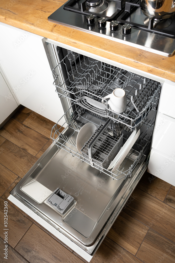 Open dishwasher with clean dishes, close up