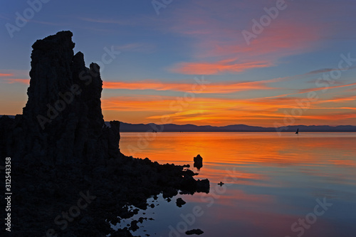 Mono Lake at dawn with tufa formations and reflections in calm water, California, USA
