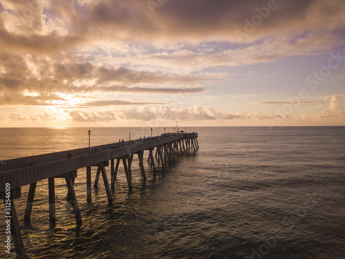 aerial view of Ocean and wooden pier at sunrise © Nathan