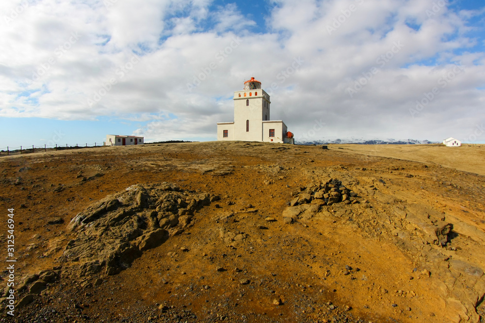 White lighthouse against a cold Atlantic ocean