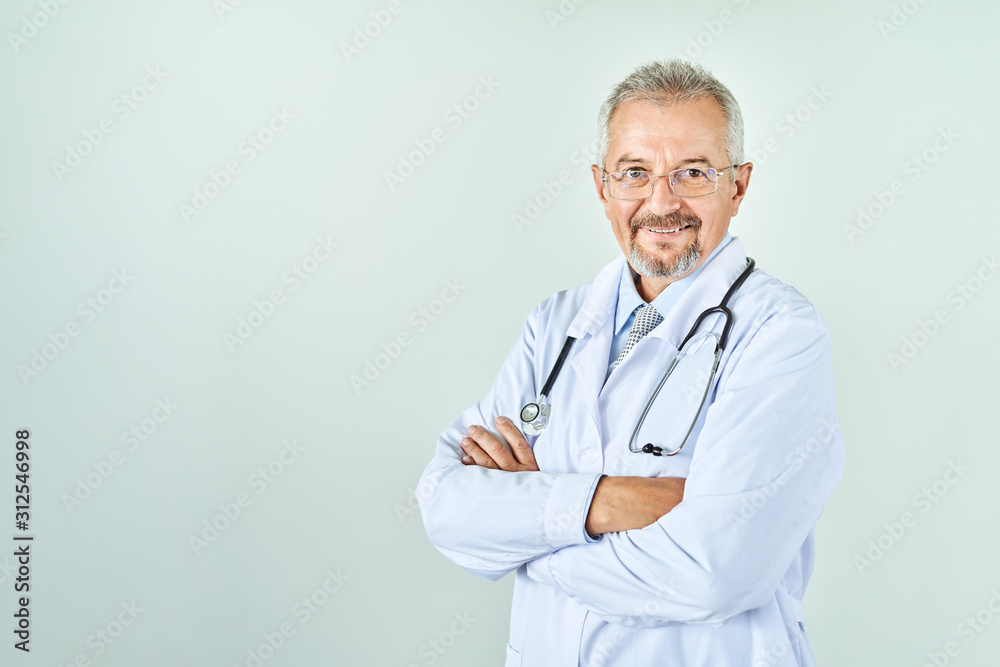 Cheerful mature doctor posing and smiling at camera, healthcare and medicine. Cheerful mature doctor posing and smiling at camera, healthcare and medicine.