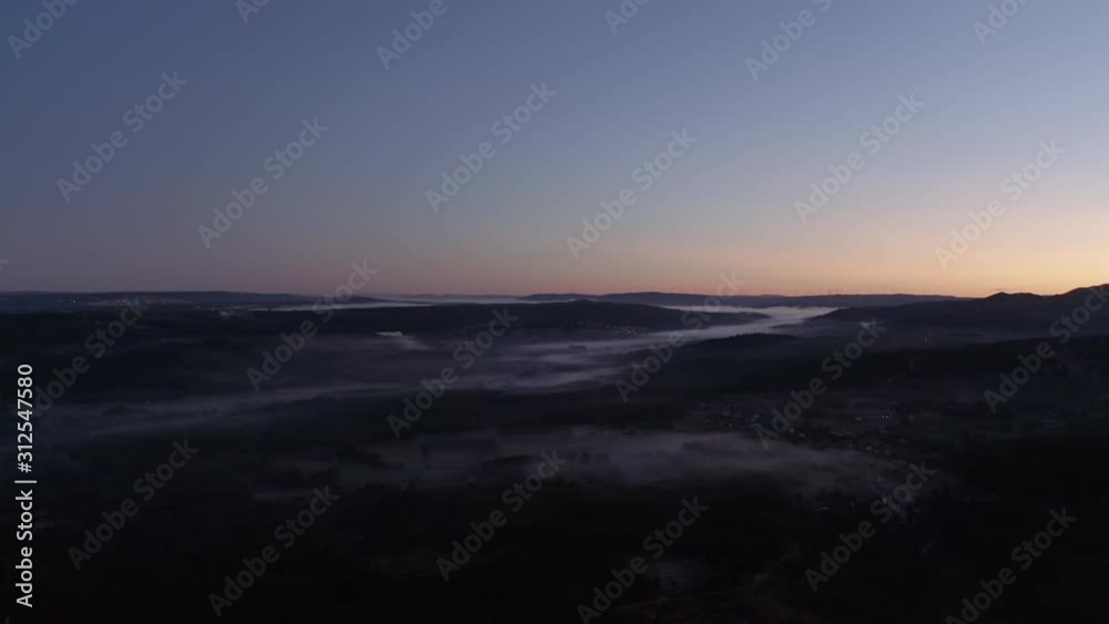 Aerial shot of a river of mist trought the mountains during the sunrise. Amazing view and beautiful colors. Aerial shot of a river of mist trought the mountains during the sunrise. Amazing view and beautiful colors.