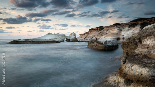 Rocky seashore seascape with wavy ocean at sea caves coastal area in Paphos, Cyprus