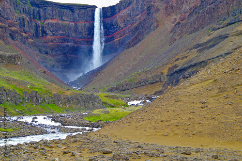 Impressive and breathtaking view onto Iceland´s fourth tallest or highest waterfall cascade Hengifoss with beautiful natural landscape and scenery and visible Paleosol photo