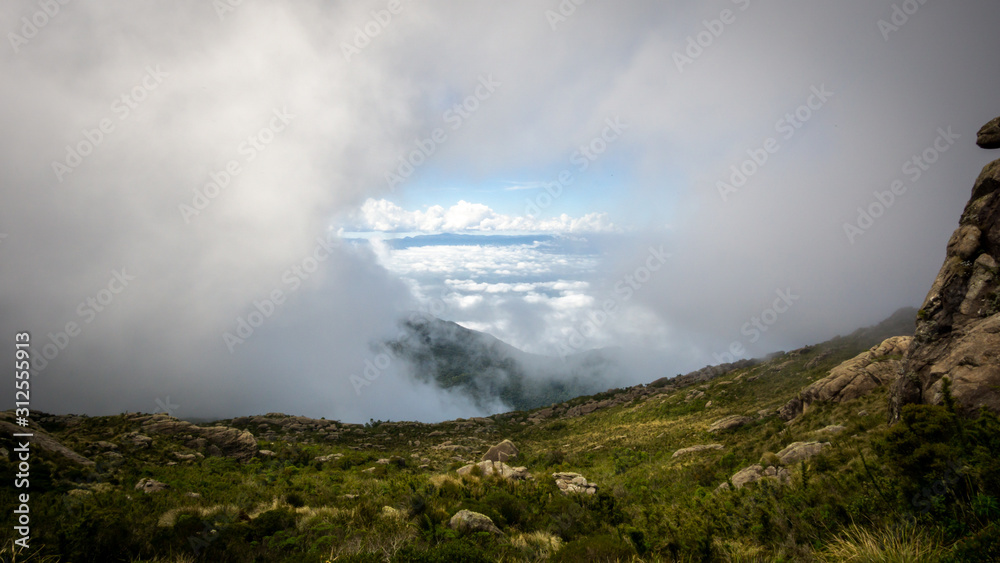 A window of valley between opened in the clouds