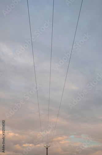 France; ligne électrique aérienne devant un ciel nuageux. overhead power line in front of a cloudy sky.
