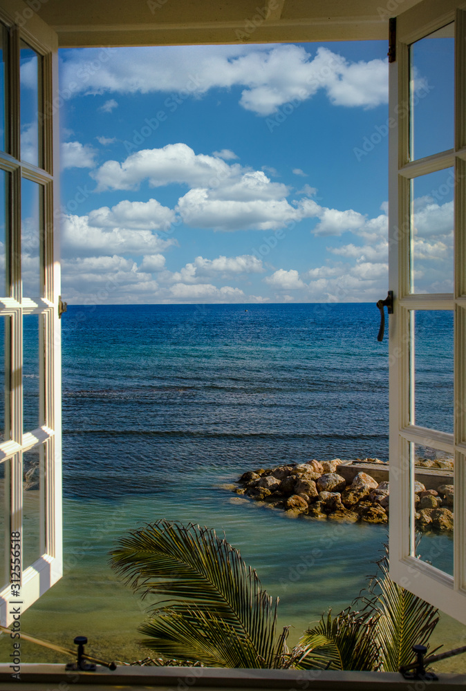 Fototapeta Looking trough a window on a caribbean beach